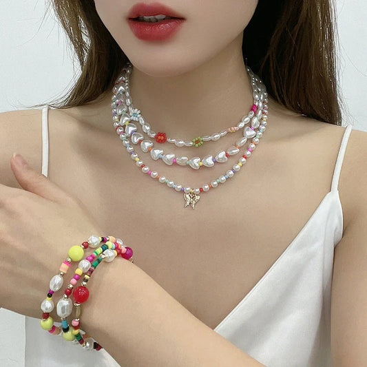 A close-up view of a gold-plated multi-strand necklace featuring delicate imitation pearls arranged in a geometric pattern.