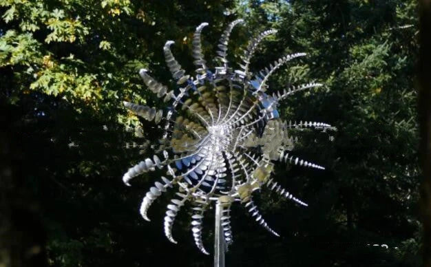 Elegant revolving metal windmill outdoor ornament with dual-layered blades creating a mesmerizing display in the garden