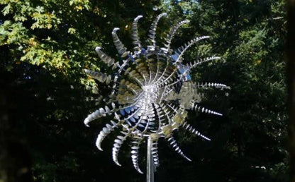 Elegant revolving metal windmill outdoor ornament with dual-layered blades creating a mesmerizing display in the garden