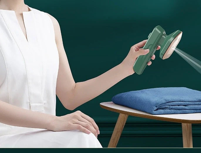 Handheld garment steamer in green, compact and lightweight for easy ironing and cleaning