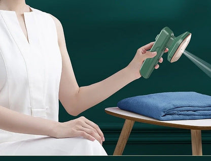 Handheld garment steamer in green, compact and lightweight for easy ironing and cleaning