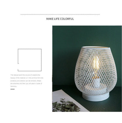 Retro iron art table lamp with hollowed out birdcage design and glass shade