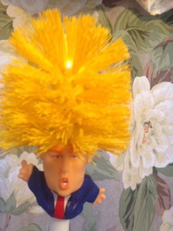 Funny Donald Trump-themed toilet brush with a sturdy handle and hanging slot for easy storage and use