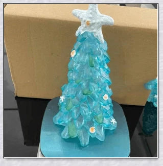 Handcrafted sea glass Christmas tree with blue, green, and turquoise sea glass, seashells, and starfish