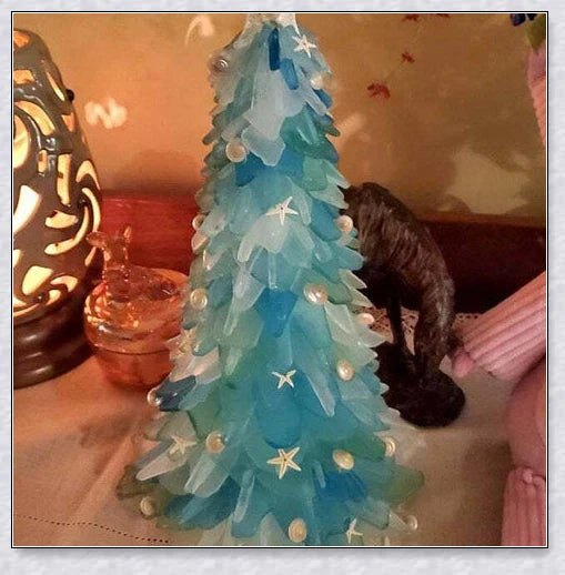Handcrafted sea glass Christmas tree with blue, green, and turquoise sea glass, seashells, and starfish