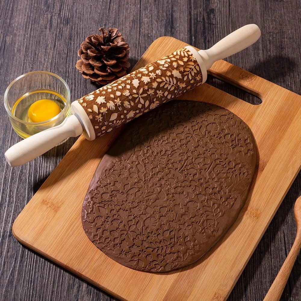 Embossed rolling pin made of natural wood with intricate designs for creating textured baked goods