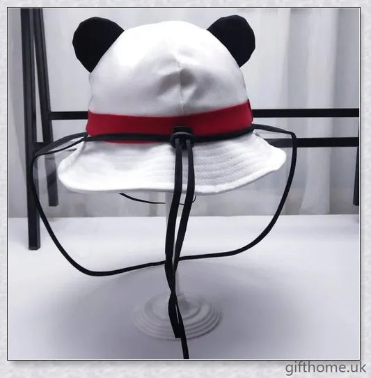 A baby wearing a cotton sun hat with a panda print design, offering protection from the sun and spray.
