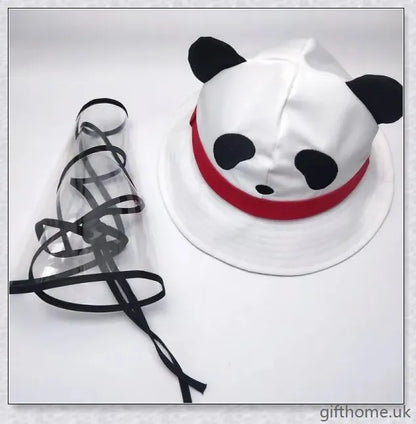 A baby wearing a cotton sun hat with a panda print design, offering protection from the sun and spray.
