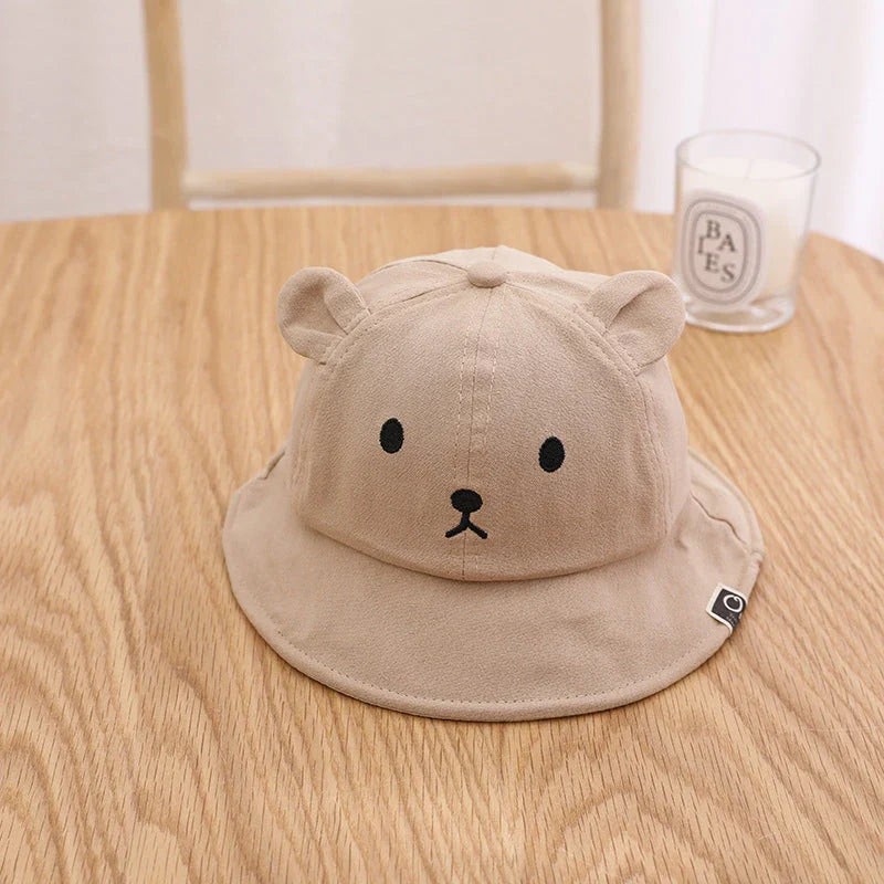 A cosy baby sun hat with cute bear ears, made from soft cotton and polyester for breathability and comfort