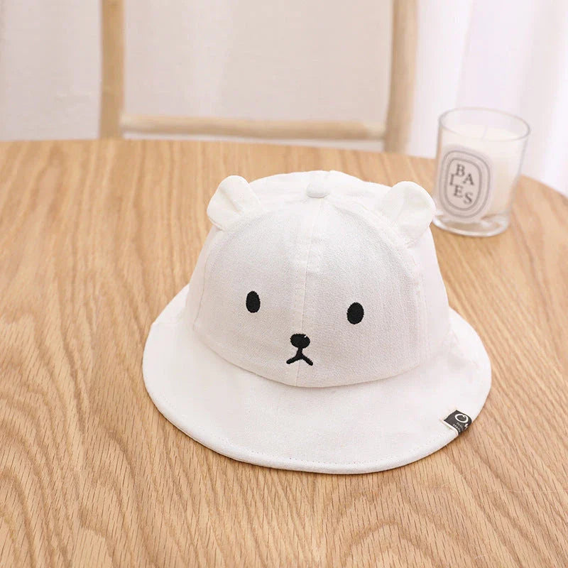 A cosy baby sun hat with cute bear ears, made from soft cotton and polyester for breathability and comfort
