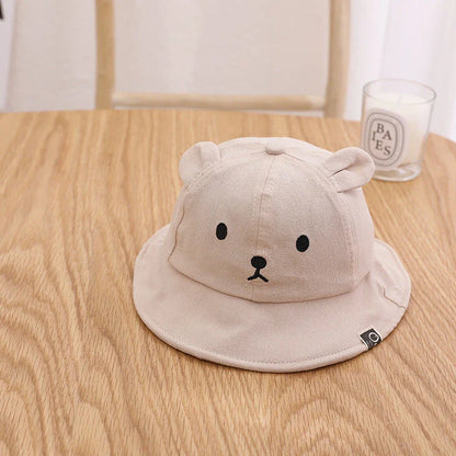 A cosy baby sun hat with cute bear ears, made from soft cotton and polyester for breathability and comfort