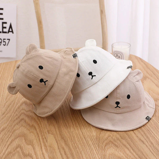 A cosy baby sun hat with cute bear ears, made from soft cotton and polyester for breathability and comfort