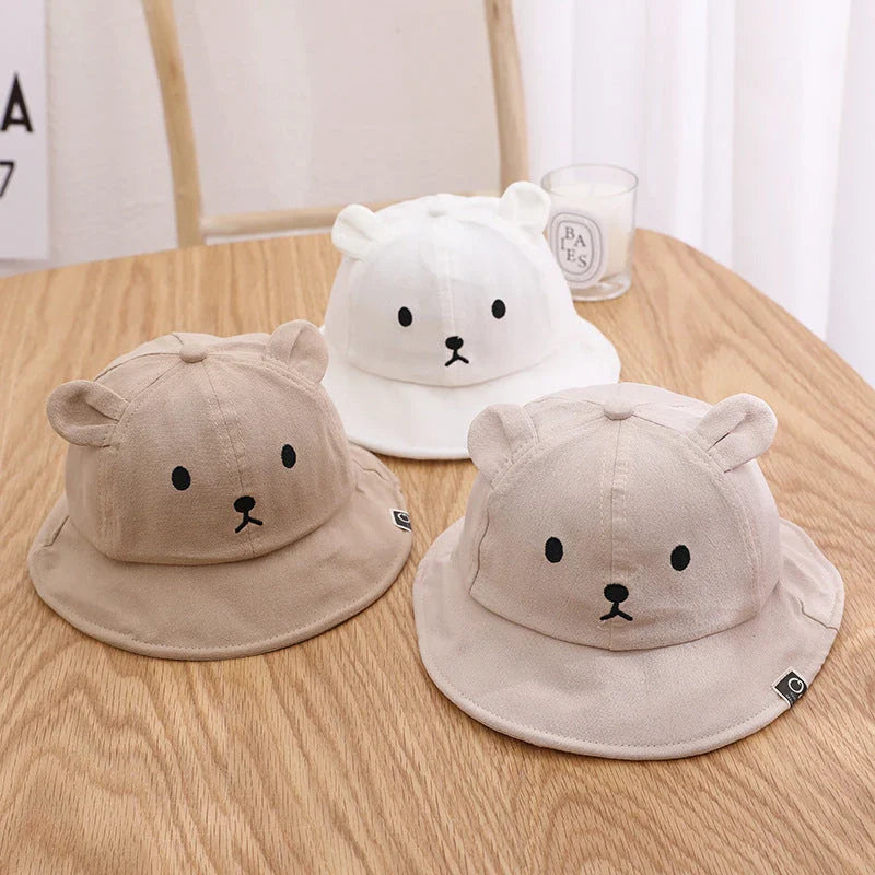 A cosy baby sun hat with cute bear ears, made from soft cotton and polyester for breathability and comfort
