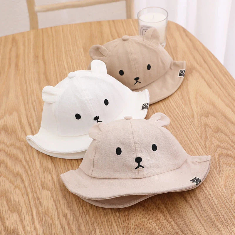 A cosy baby sun hat with cute bear ears, made from soft cotton and polyester for breathability and comfort