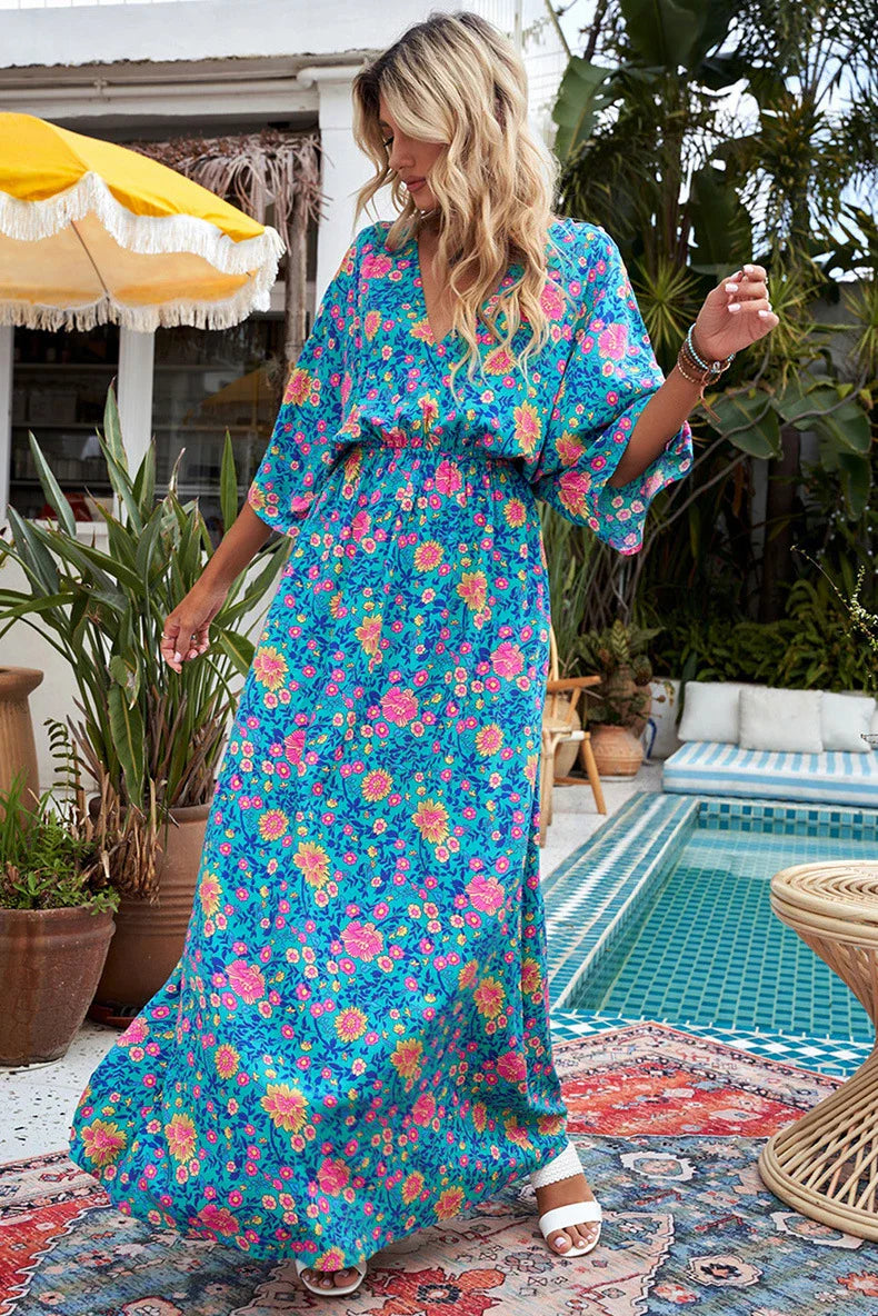 A floral print dress with an elastic waist and long loose sleeves, perfect for a relaxed and elegant British style.