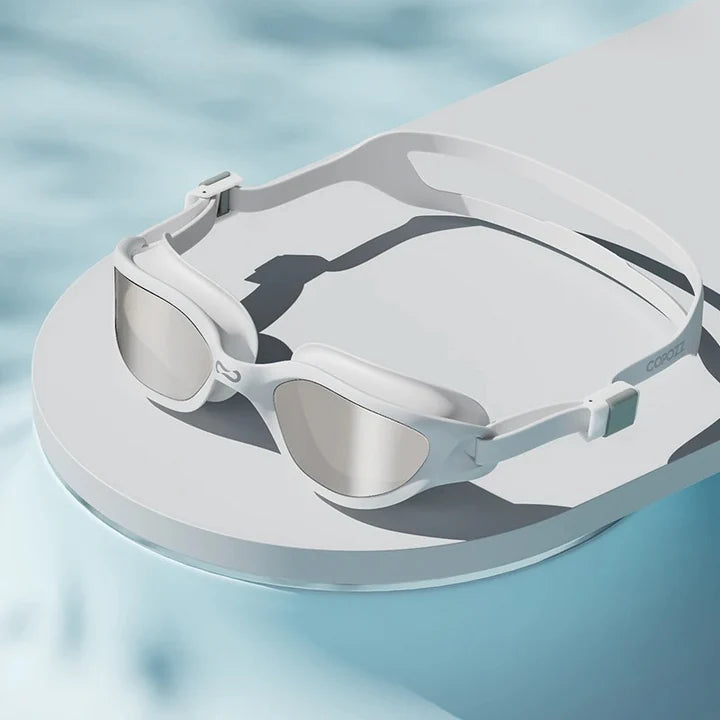 A pair of professional anti-fog mirrored swimming goggles with adjustable silicone strap and UV protection