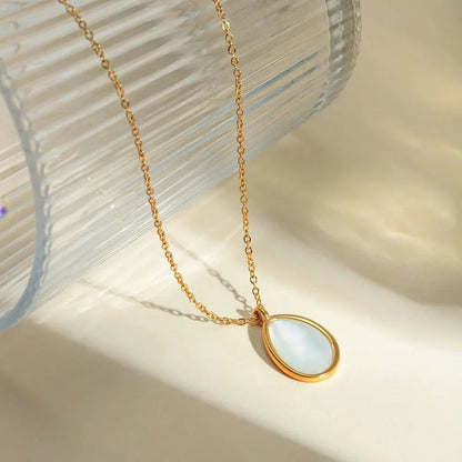 A luxury opal inlaid stainless steel drop pendant necklace with a 18K gold plating, showcasing a captivating and sophisticated design.