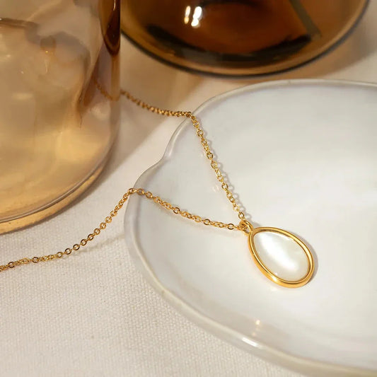 A luxury opal inlaid stainless steel drop pendant necklace with a 18K gold plating, showcasing a captivating and sophisticated design.