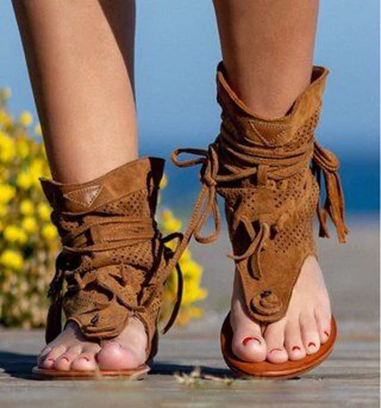 A pair of white, flat, frosted fringe sandals with a comfortable rubber sole