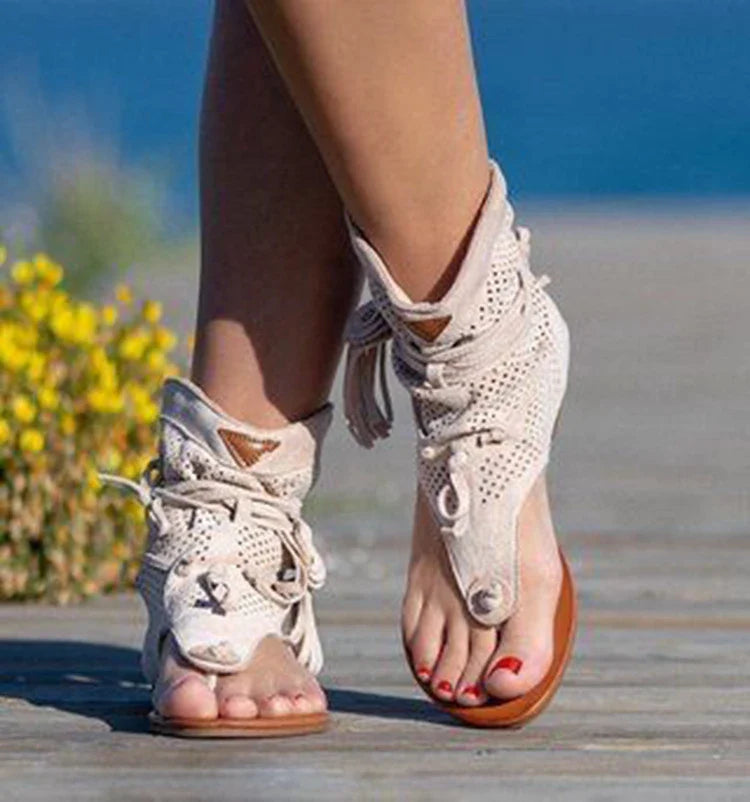 A pair of white, flat, frosted fringe sandals with a comfortable rubber sole