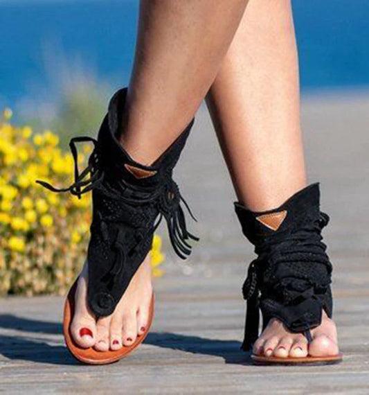A pair of white, flat, frosted fringe sandals with a comfortable rubber sole