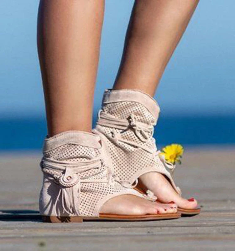 A pair of white, flat, frosted fringe sandals with a comfortable rubber sole