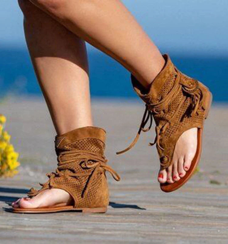 A pair of white, flat, frosted fringe sandals with a comfortable rubber sole