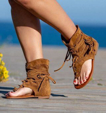 A pair of white, flat, frosted fringe sandals with a comfortable rubber sole