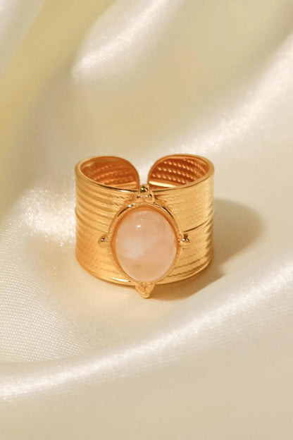 A close-up view of a polished 18K gold-plated wide-open ring, showcasing its unique and eye-catching design.