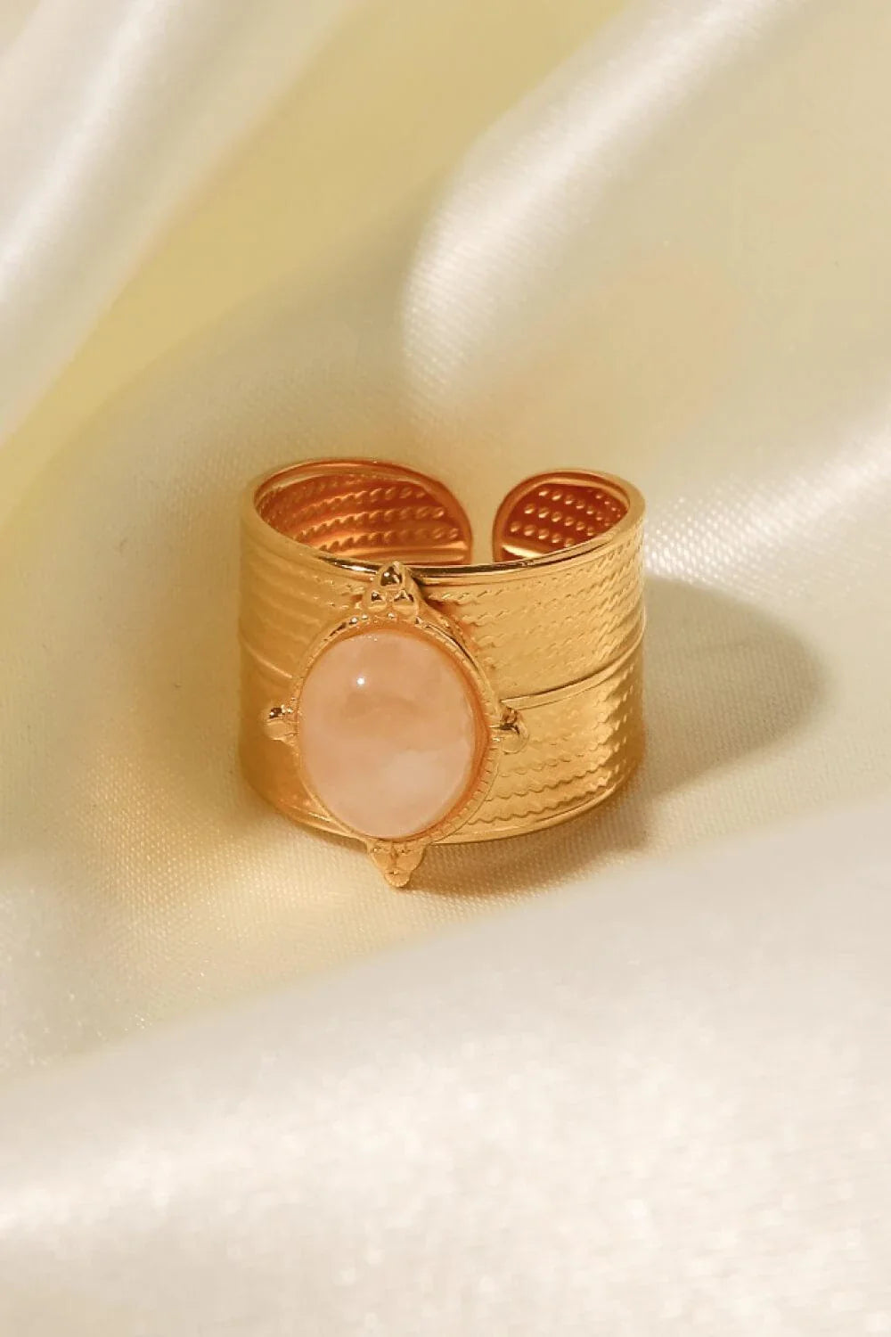 A close-up view of a polished 18K gold-plated wide-open ring, showcasing its unique and eye-catching design.