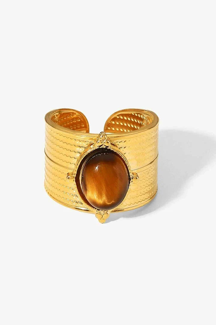 A close-up view of a polished 18K gold-plated wide-open ring, showcasing its unique and eye-catching design.