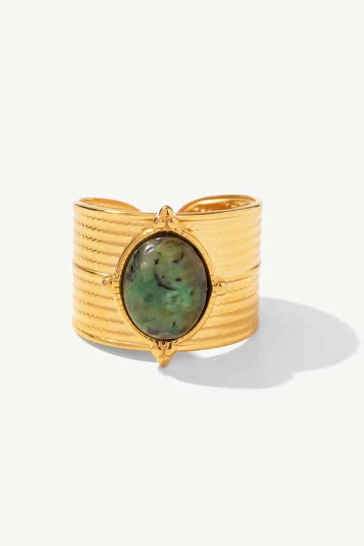 A close-up view of a polished 18K gold-plated wide-open ring, showcasing its unique and eye-catching design.