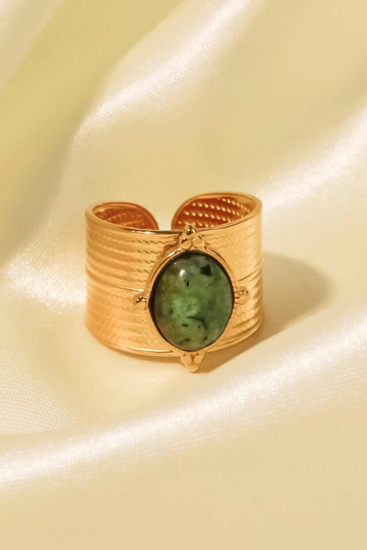 A close-up view of a polished 18K gold-plated wide-open ring, showcasing its unique and eye-catching design.