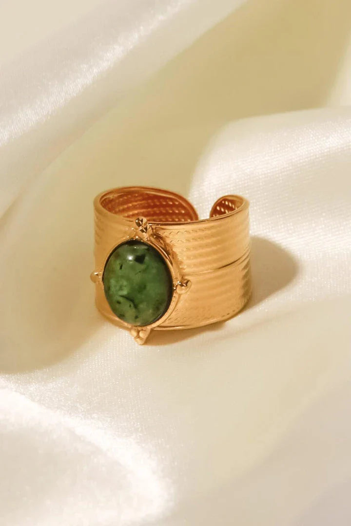 A close-up view of a polished 18K gold-plated wide-open ring, showcasing its unique and eye-catching design.