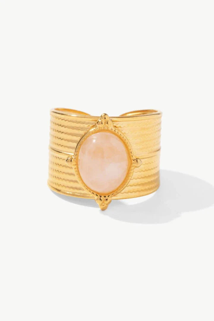 A close-up view of a polished 18K gold-plated wide-open ring, showcasing its unique and eye-catching design.