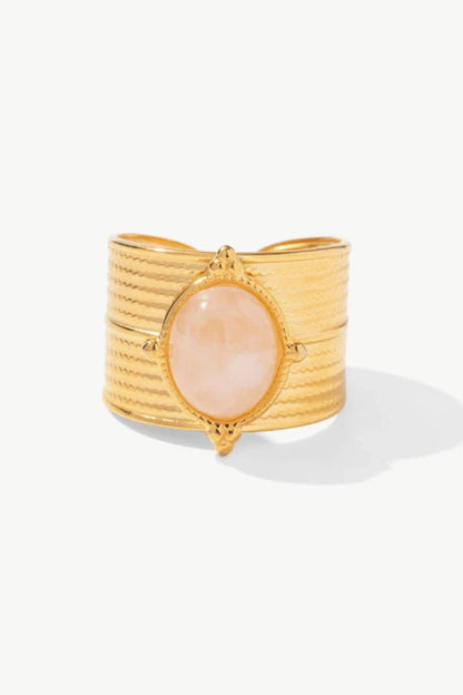 A close-up view of a polished 18K gold-plated wide-open ring, showcasing its unique and eye-catching design.