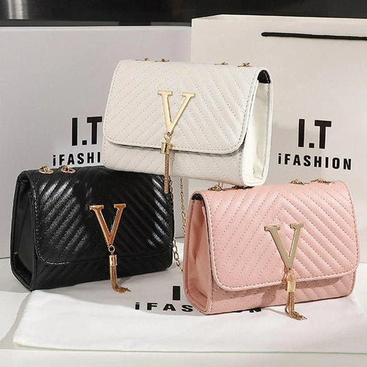 Luxury white embroidered crossbody bag with sequined tassel and elegant flap design