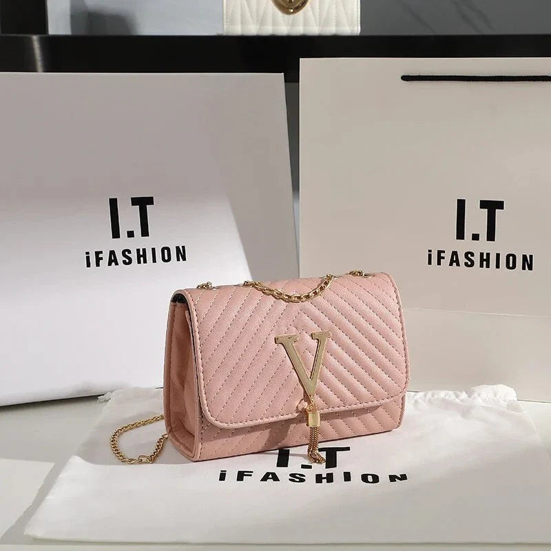 Luxury white embroidered crossbody bag with sequined tassel and elegant flap design