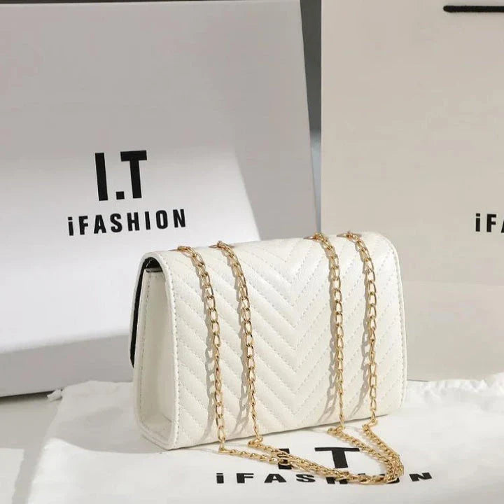 Luxury white embroidered crossbody bag with sequined tassel and elegant flap design