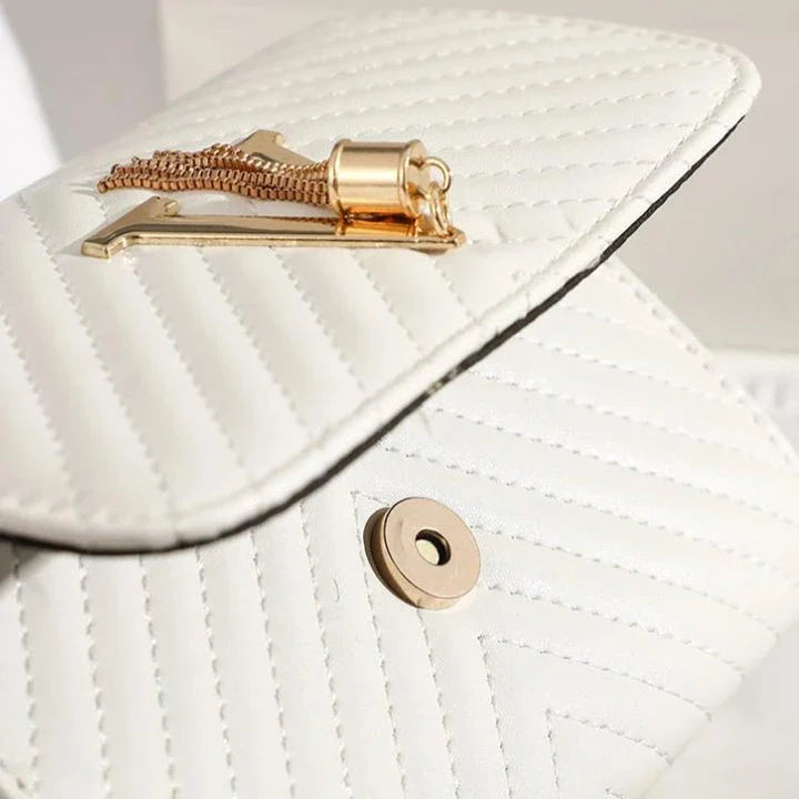 Luxury white embroidered crossbody bag with sequined tassel and elegant flap design