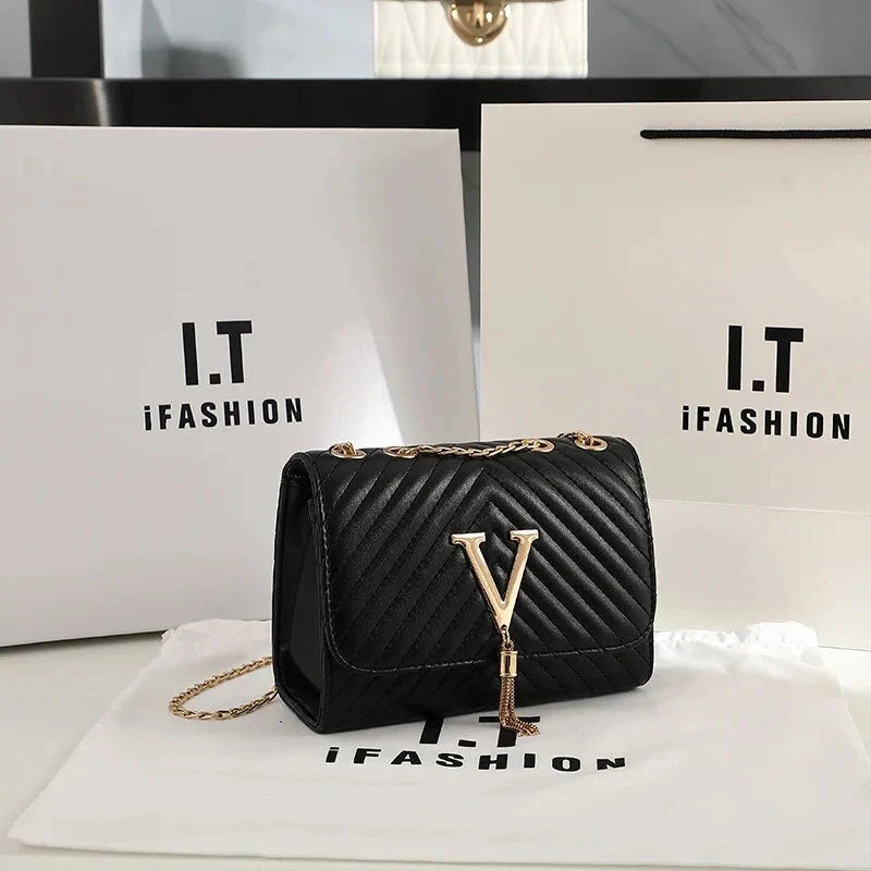 Luxury white embroidered crossbody bag with sequined tassel and elegant flap design