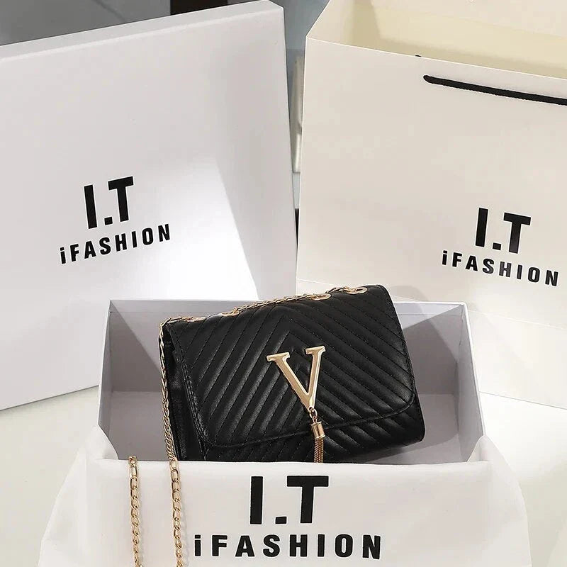Luxury white embroidered crossbody bag with sequined tassel and elegant flap design