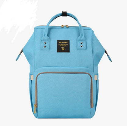 Multi-purpose large capacity mummy bag in blue, with a sleek backpack-inspired design and ample storage for parenting essentials