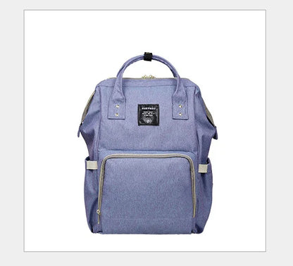 Multi-purpose large capacity mummy bag in blue, with a sleek backpack-inspired design and ample storage for parenting essentials
