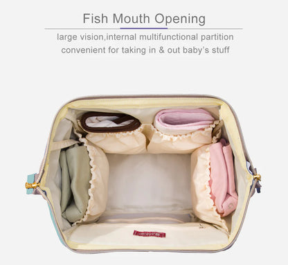 Multi-purpose large capacity mummy bag in blue, with a sleek backpack-inspired design and ample storage for parenting essentials