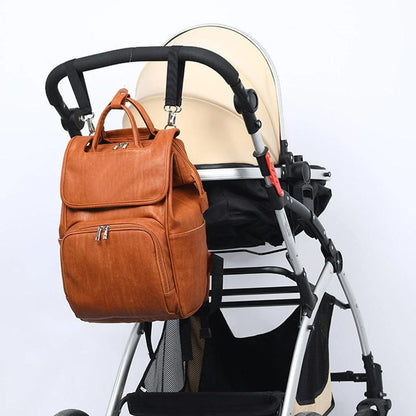 PU Leather Diaper Bag Backpack in Black, featuring side pocket, anti-theft compartment, and stroller straps