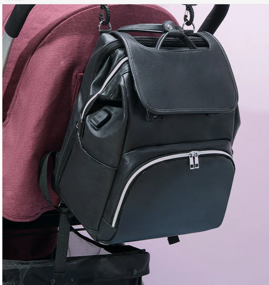 PU Leather Diaper Bag Backpack in Black, featuring side pocket, anti-theft compartment, and stroller straps