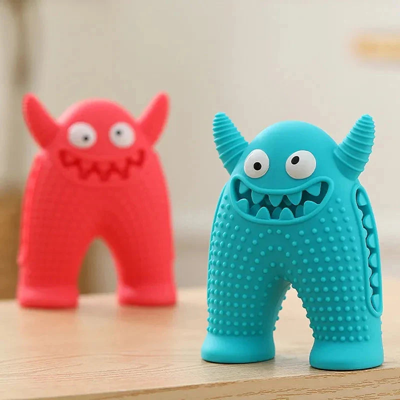 A cute interactive silicone dog toy shaped like a little monster, designed to clean teeth and promote dental health while providing entertainment.