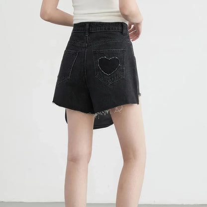 Women's high-waisted denim shorts with asymmetric hemline in black colour