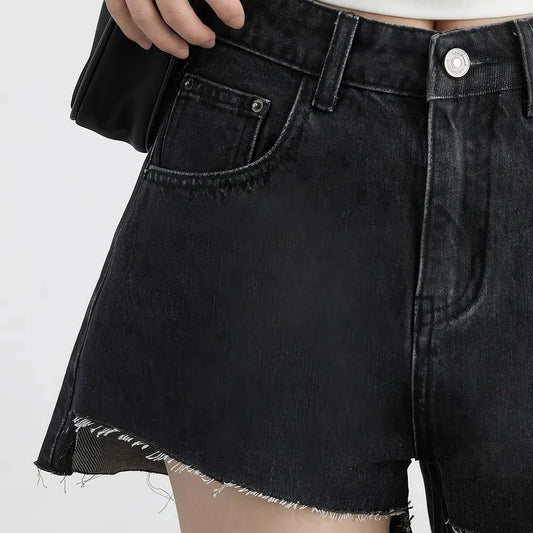 Women's high-waisted denim shorts with asymmetric hemline in black colour